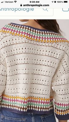 the back of a woman's sweater with crochet