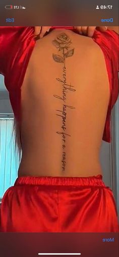 the back of a woman's body with words on it and a rose tattoo