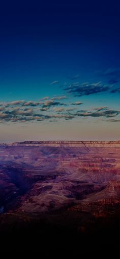 the sun is setting at the grand canyon