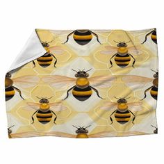 a yellow and black bee pattern on a white background fleece blanket with two bees in the center