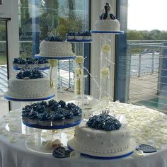 three tiered wedding cake with white and blue decorations