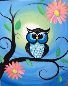 an owl sitting on a tree branch with flowers painted on it's back side