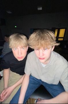 two young men sitting next to each other