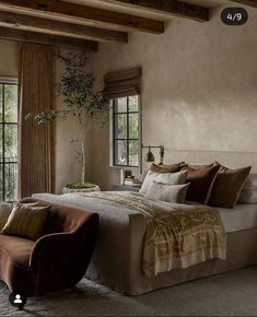 a large bed in a bedroom next to two windows