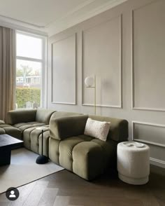 a living room filled with furniture and a large window