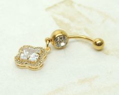 14g gold plated surgical steel belly ring features a golden floral charm accented with large diamond shape in the center. Belly ring measures 1 5/8 inches long total length. Barbell is 14g gold plated surgical steel with a clear crystal gem. For Belly Button Rings: https://www.etsy.com/shop/AllAboutClass?section_id=18474235&ref=shopsection_leftnav_1 For Add a Charm Belly Rings: https://www.etsy.com/shop/AllAboutClass?section_id=14180524&ref=shopsection_leftnav_2 For charms and supplies s Adjustable Gold Belly Rings For Wedding, Solid Gold Belly Button Ring, Gold Belly Ring As A Gift, Elegant Gold Belly Rings Gift, Sun Gold Belly Button Ring, Elegant 14k Gold Belly Rings For Gift, Gold Dangle Belly Ring, Body Jewerly, Bellybutton Piercings