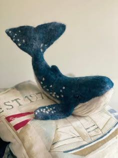 a stuffed whale on top of a pillow