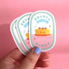 a hand holding three stickers with the words brunch and bunce on them