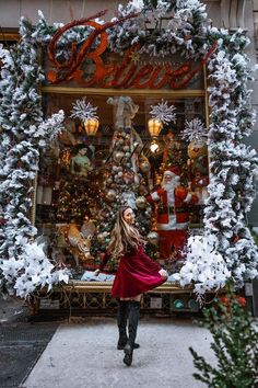 a woman standing in front of a christmas display