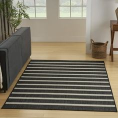 a black and white striped rug in a living room