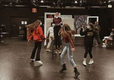 a group of people standing on top of a wooden floor