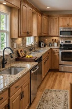 a kitchen with wooden cabinets and granite counter tops, stainless steel appliances and wood flooring