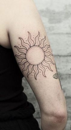 a woman with a sun tattoo on her arm