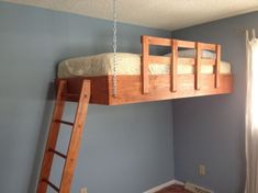 a wooden bunk bed sitting in a bedroom next to a window