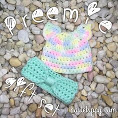 a crocheted hat and diaper cover laying on rocks with the words dream written above it