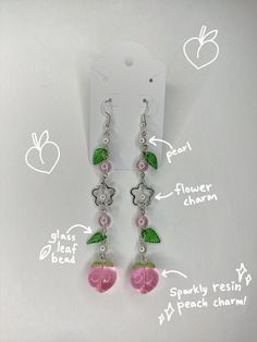 ★ Cute, aesthetic, and intricate earrings, made with steel flower charm, glass leaf beads, translucent pink beads, imitation pearls, and sparkling resin peach charm! ★ Perfect earrings to wear anywhere, detailed and interesting, as well as being very cute! ★ These earrings are homemade, and made and packaged with care! ★ Comes with earring backings for extra comfort :) ★ Comes with sticker freebies!