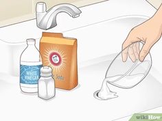 someone is washing their hands with soap and other cleaning products on the sink counter top