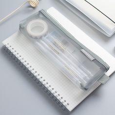 an open notebook sitting on top of a desk next to a computer mouse and keyboard