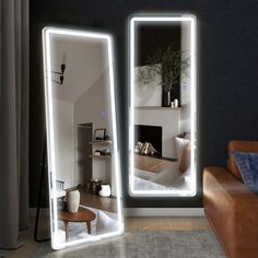 a living room with two large mirrors on the wall