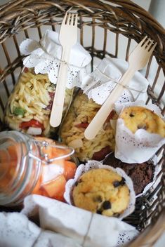 a basket filled with food and utensils on top of a table