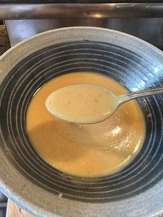 a spoon in a bowl filled with soup