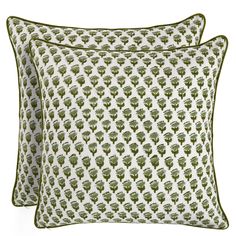 two pillows with green and white designs on them