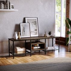 a living room filled with furniture next to a wall mounted art piece on top of a wooden floor