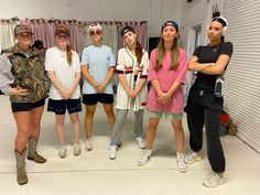 a group of young women standing next to each other in front of a white wall