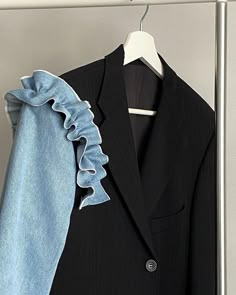 a suit and tie hanging on a rack