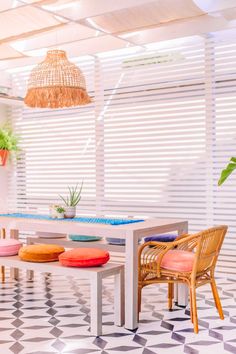 a dining room table and chairs with colorful cushions