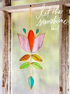 a stained glass window with a flower hanging from it's side