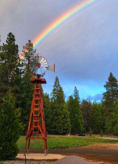 a windmill with a rainbow in the background