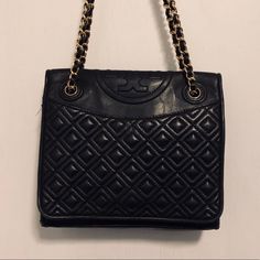 This Tory Burch Quilted Leather Bag Is 9” X 7.5”. It Can Be Worn As A Cross Body Or Over The Shoulder Depending How You Adjust The Chains. About 4” Deep. Used. Slight Tears On Bottom Right Corner Of Bag Black Leather With Gold Hardware Slight Scuffs Comes With Original Dust Bag Quilted Purse, Tory Burch Purse, Quilted Purses, Tory Burch Bags, Tory Burch Bag, Quilted Leather, Gold Hardware, Cross Body, Tory Burch