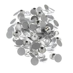 a pile of silver colored buttons on a white background