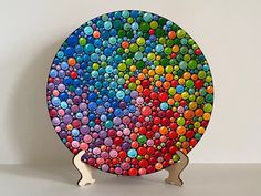 a colorful plate is sitting on a stand