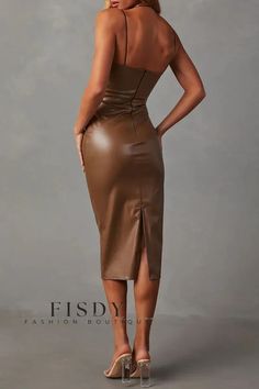 a woman in a brown leather dress with her back turned to the camera and looking down