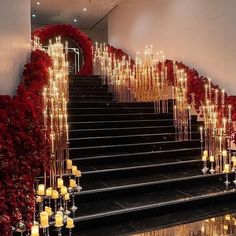 the stairs are decorated with candles and red flower garlands for a festive effect