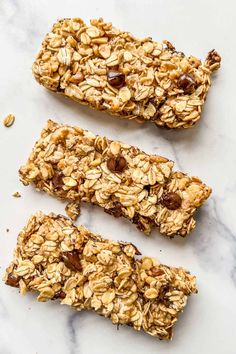 three granola bars sitting on top of a marble counter