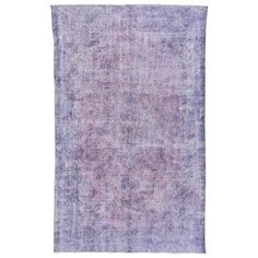 an old rug with faded purple and blue colors