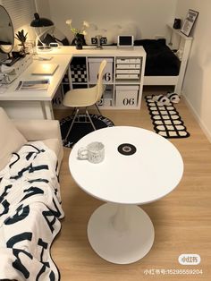 a white table sitting on top of a hard wood floor next to a desk and chair