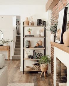 a living room filled with furniture and a fire place in front of a brick wall