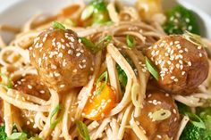 a close up of a plate of food with broccoli and meatballs on it