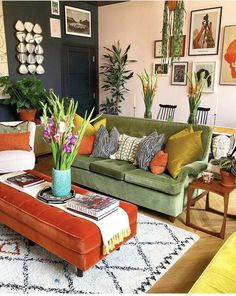 a living room filled with lots of furniture and flowers on top of a coffee table