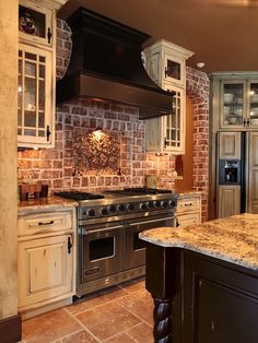 a kitchen with an oven, stove and cabinets in it's center island area