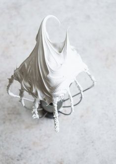 a white sculpture sitting on top of a table