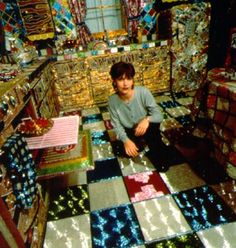 a man is sitting on the floor in a room filled with boxes