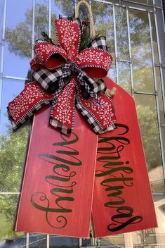 a red and black christmas door hanger with the word merry written on it