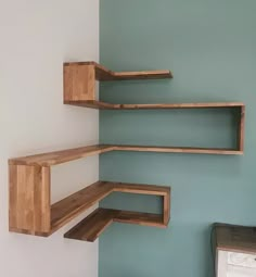 three wooden shelves in the corner of a room