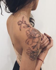 a woman with a flower tattoo on her arm