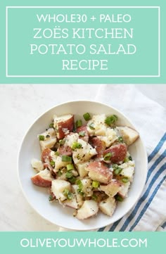 a white bowl filled with potato salad on top of a blue and white towel